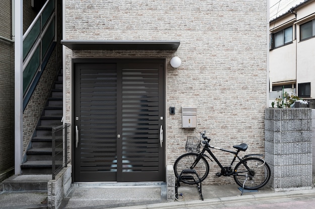 Free photo japanese house entrance and bicycle