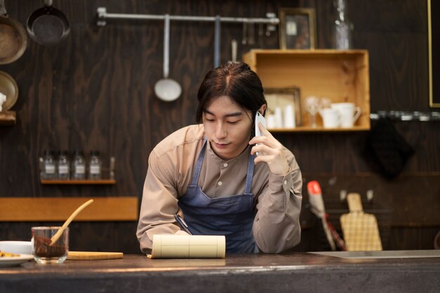 Japanese man talking on smartphone in a restaurant