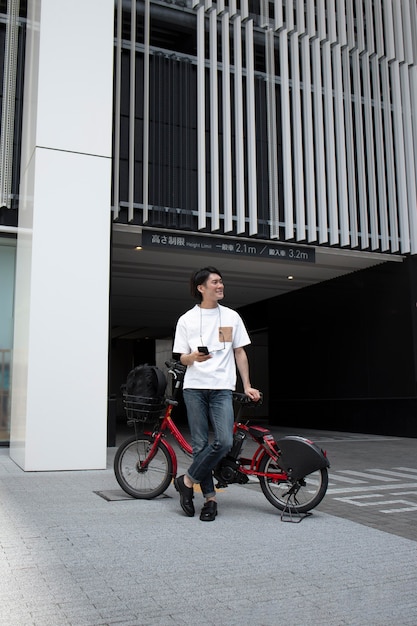 Free photo japanese man with his bike outdoors