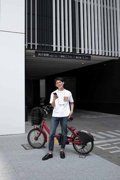 Free photo japanese man with his bike outdoors