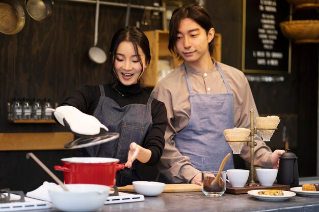 Japanese man and woman cooking in a restaurant