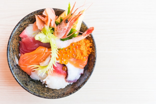 Free Photo japanese rice bowl with sashimi seafood on top