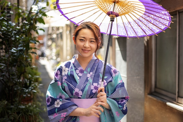 Free photo japanese wagasa umbrella help by young woman