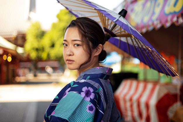 Free photo japanese wagasa umbrella help by young woman