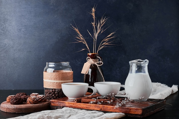 Jar of milk with coffee beans and chocolate pralines.