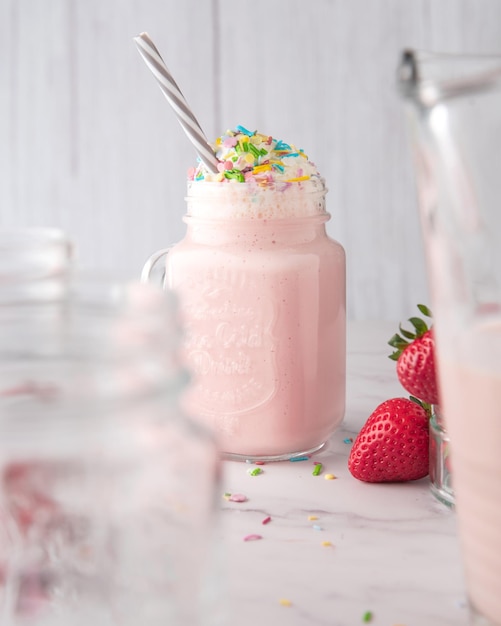 Jar of a strawberry refreshing drink with various sugar sprinkles