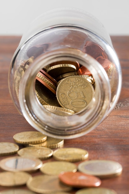 Free Photo jar with coins on table