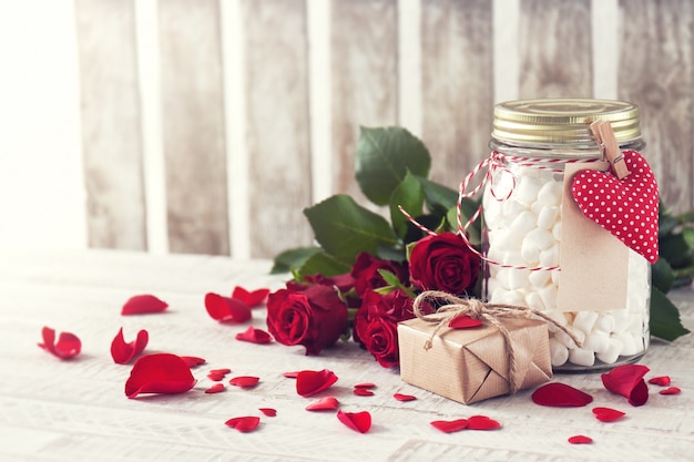 Jar with marshmallow, gift and bouquet of roses. Love, sweet or