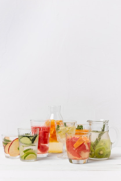 Jars with fruits flavor drinks on table