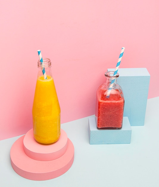 Jars with healthy smoothie on desk