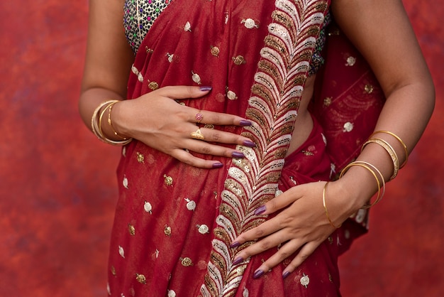 Jewel details on hands of woman wearing a sari dress