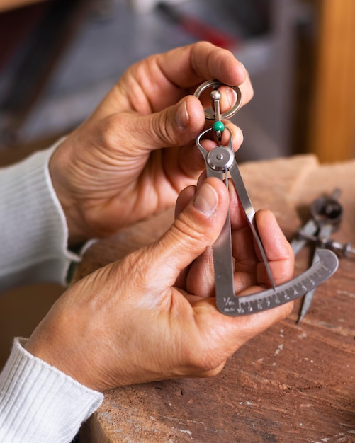 Free photo jeweler hands making a ring