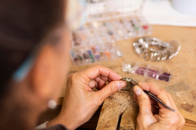 Free Photo jeweler hands putting a jewel on ring