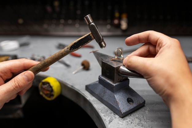 Free Photo jeweler's hands making jewellery