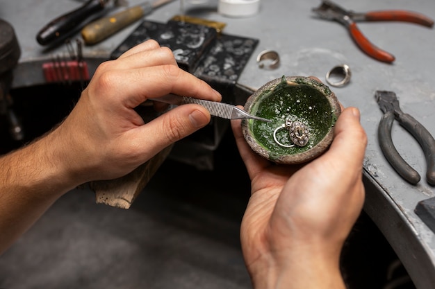 Jeweler's hands making jewellery