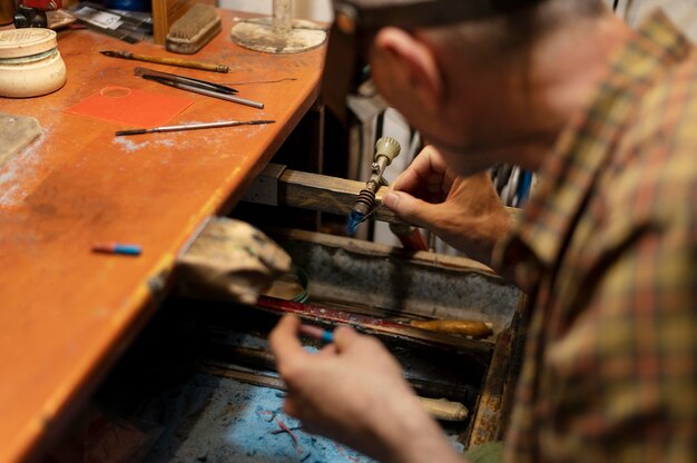 Jewelry maker working alone in the atelier