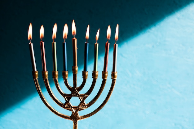 Free Photo jewish menorah with candles burning