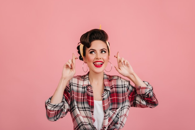 Free Photo jocund european girl in checkered shirt posing on pink background. pretty pinup woman expressing positive emotions.