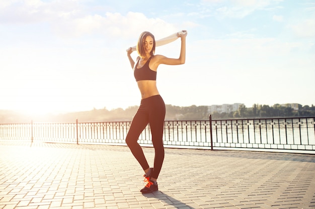 Jogger by the lake at sunset