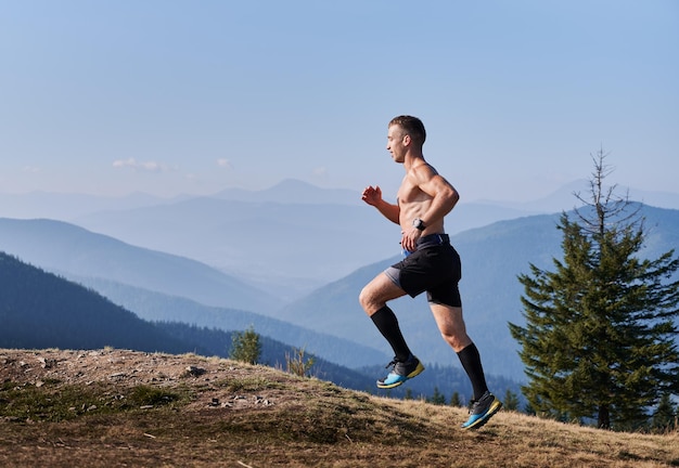 Jogging uphill in the mountains at summer