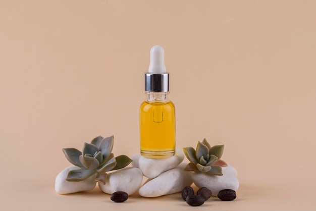 Free photo jojoba oil dropper arrangement