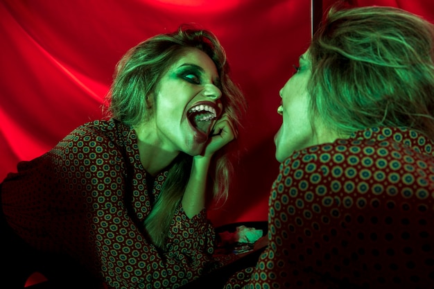 Free Photo joker woman laughing in the mirror