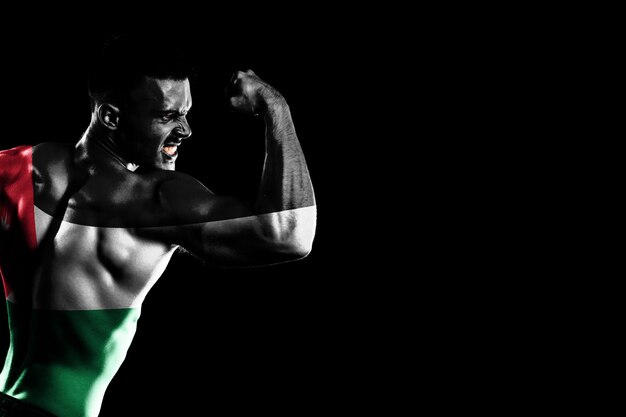 Jordan flag on handsome young muscular man black background