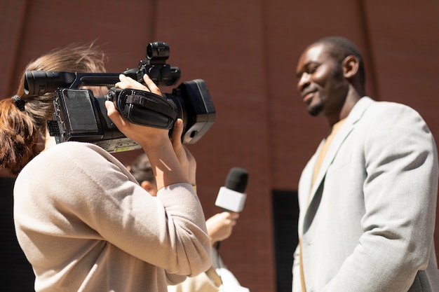 Journalist taking an interview from a man