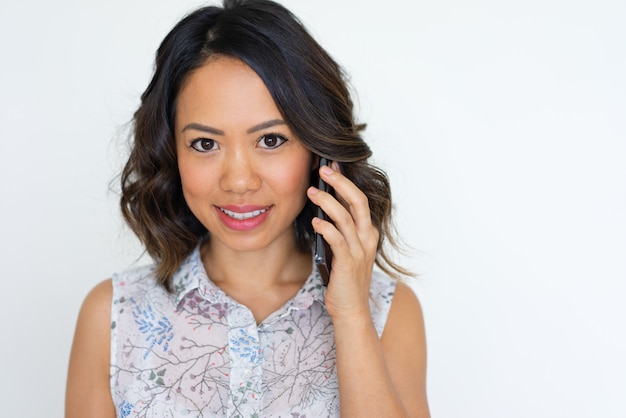 Free photo joyful asian girl speaking on phone