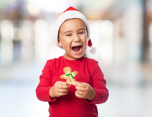 Joyful child posing with a delicious cookie