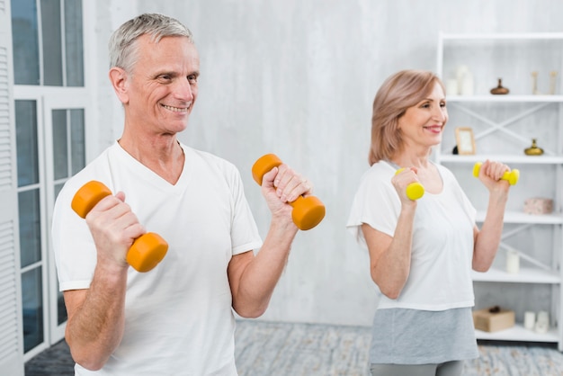 Joyful couple exercising at home