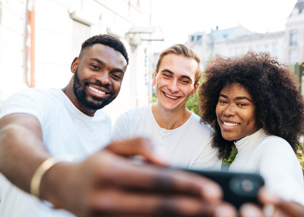 Joyful friends outdoor taking selfie