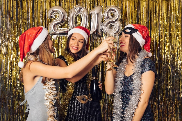 Free photo joyful girls drinking champagne on new year party