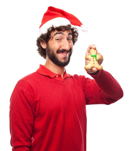 Joyful guy having a good time with his tasty cookie