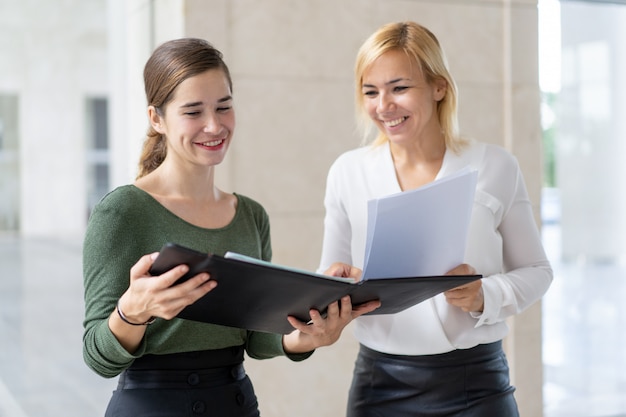 Free photo joyful managers carrying reports to boss