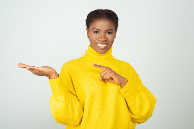 Joyful positive black woman in bright sweater