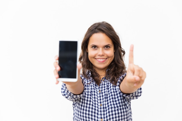 Joyful positive mobile phone user showing blank screen