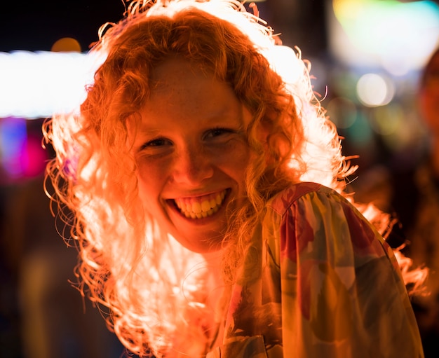 Joyful woman smiling while looking at camera