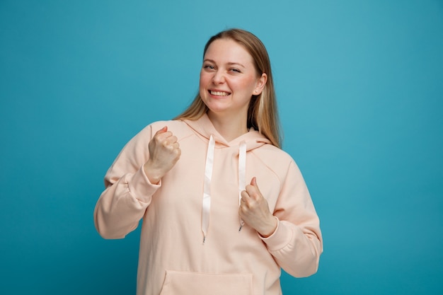 Joyful young blonde woman doing yes gesture 