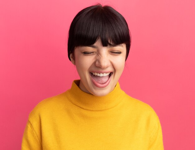 Joyful young brunette caucasian girl stands with closed eyes