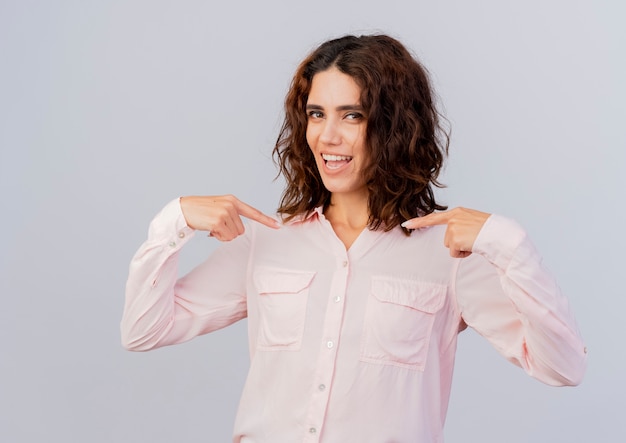 Joyful young caucasian woman points at herself with two hands