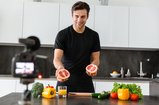 Free photo joyful young man filming his video blog episode