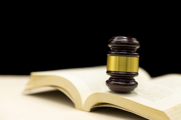 Judges gavel on book and wooden table. Law and justice concept background.