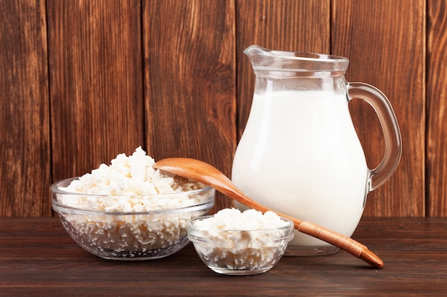 Jug of milk and bowls with cheese