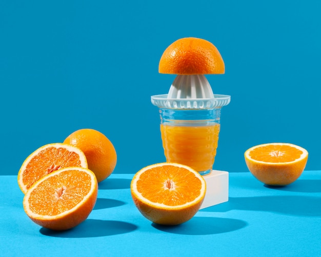 Free photo juice maker and oranges arrangement