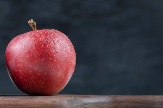 Juicy apples isolated on a wooden platter.