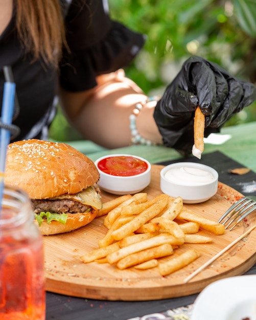 juicy burger with french fries ketchup and mayonnaise