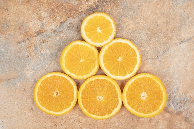 Juicy orange slices on marble surface.