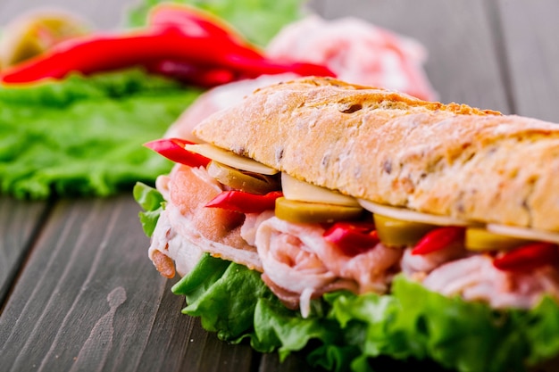 Juicy red pepper looks from under wholemeal bread in the sandwich