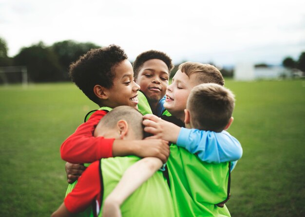 Junior football team hugging each other